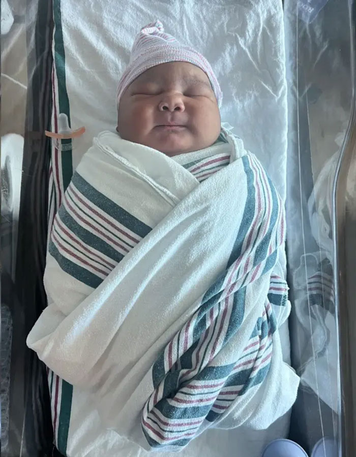 Newborn giant baby wrapped in hospital blanket, highlighting doctors sounding alarm over rise in giant baby births.
