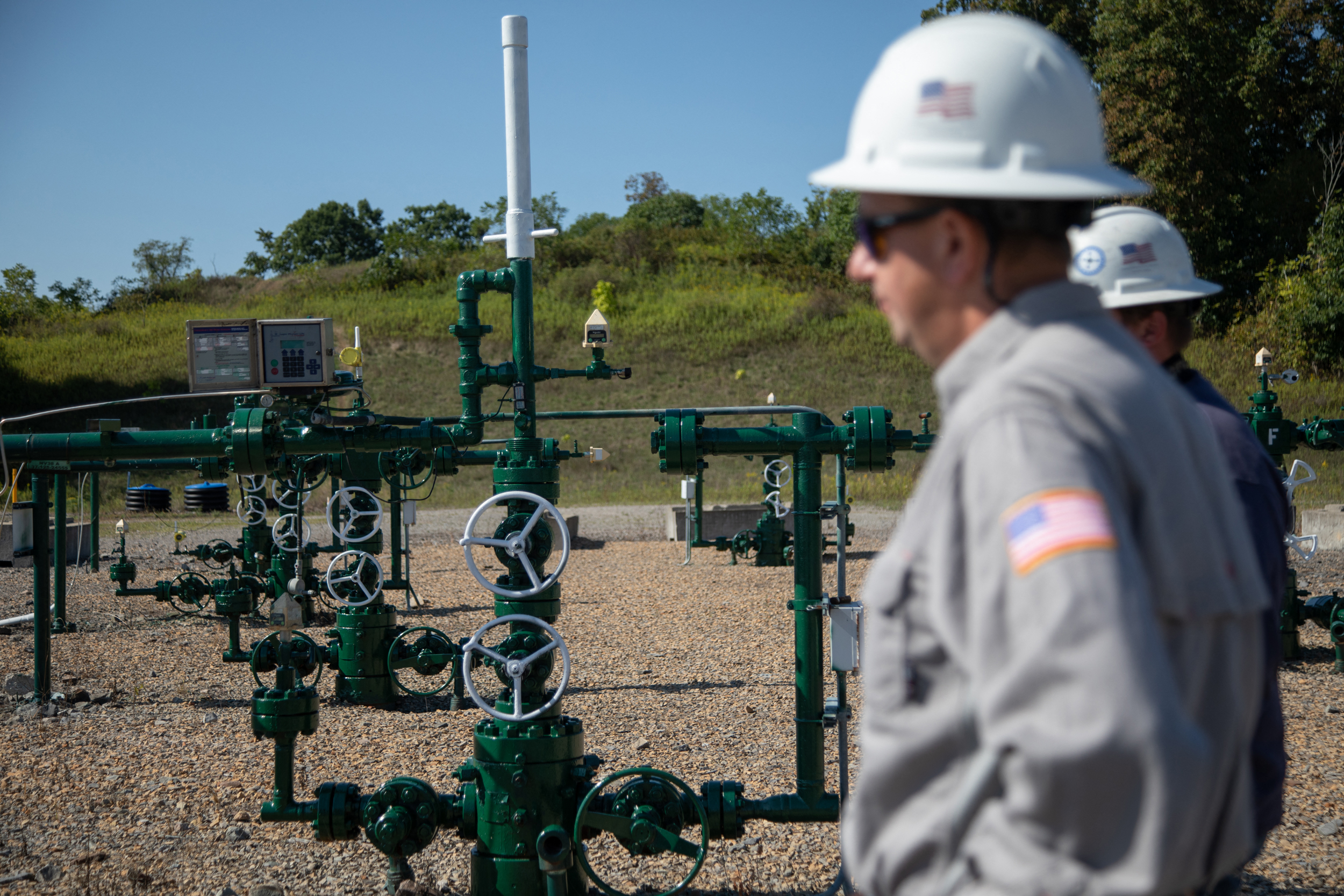 Diversified Energy workers stand by a natural gas well in Washington County, Pa., on Sept. 6, 2024. Credit: Rebecca Droke/AFP via Getty Images
