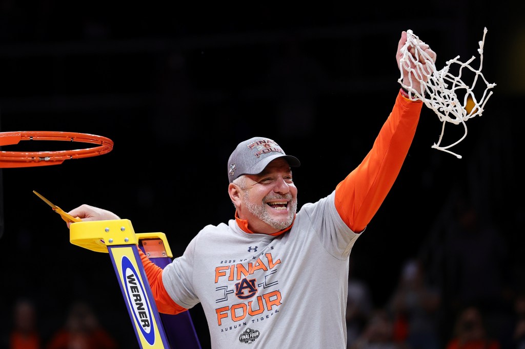 Auburn coach Bruce Pearl cuts down the nets after defeating Michigan State to reach the Final Four on March 30, 2025.