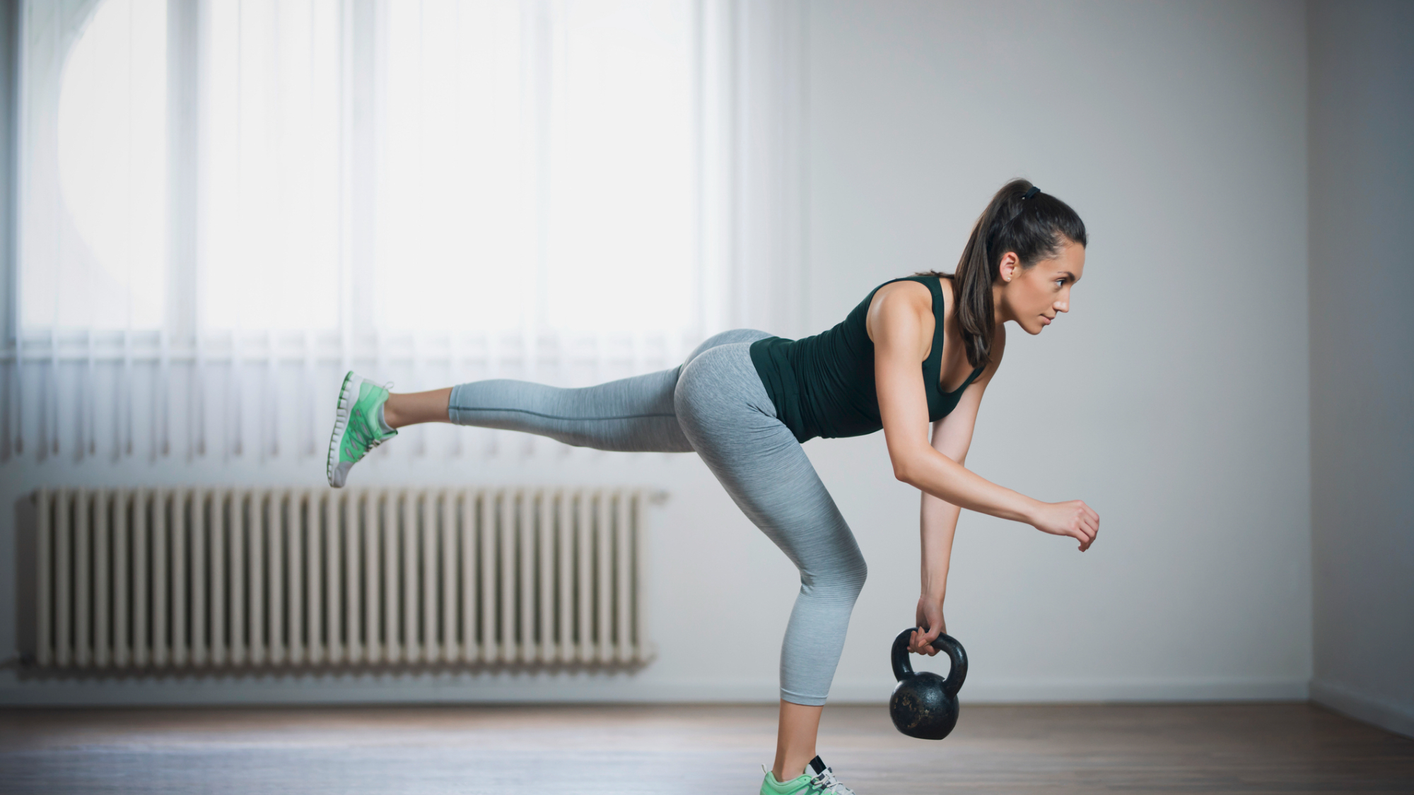 A woman performing a single-leg deadlift