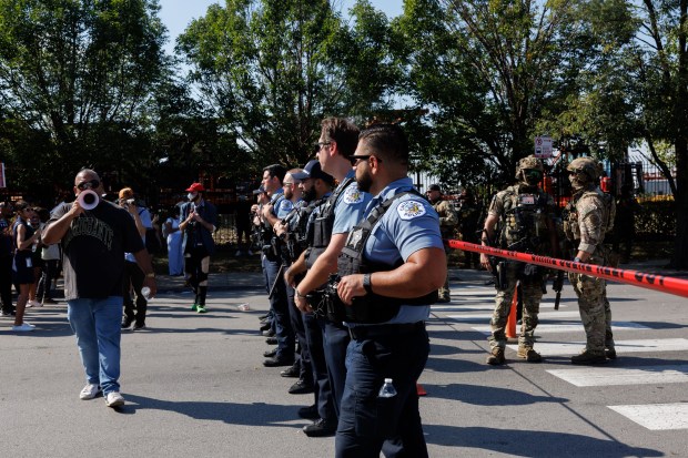 Chicago police assist federal agents as members of the community...