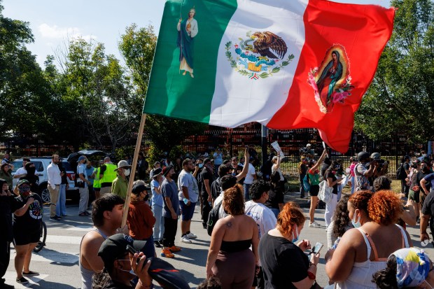Community members and activists protest federal agents's actions after a...