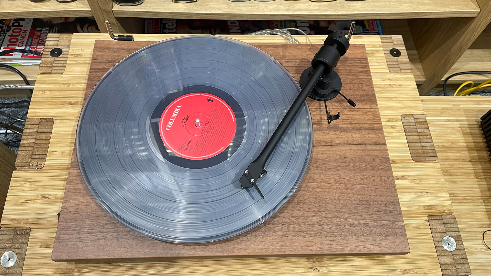 A top-down shot of a Pro-Ject T1 Evo BT turntable on a wooden surface